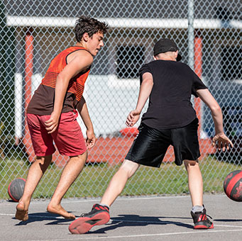 Two young boys playing basketball