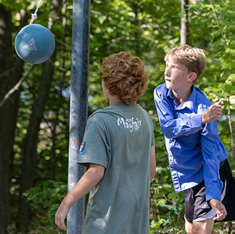 Two young boys playing Tetherball