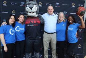 Members of Christie Lake Kids team with Ottawa BlackJacks president, Mark Wacyk, and mascot, OG.